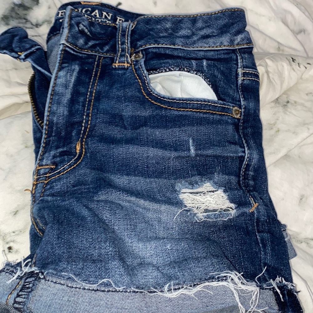 Dark wash jean shorts with small rips